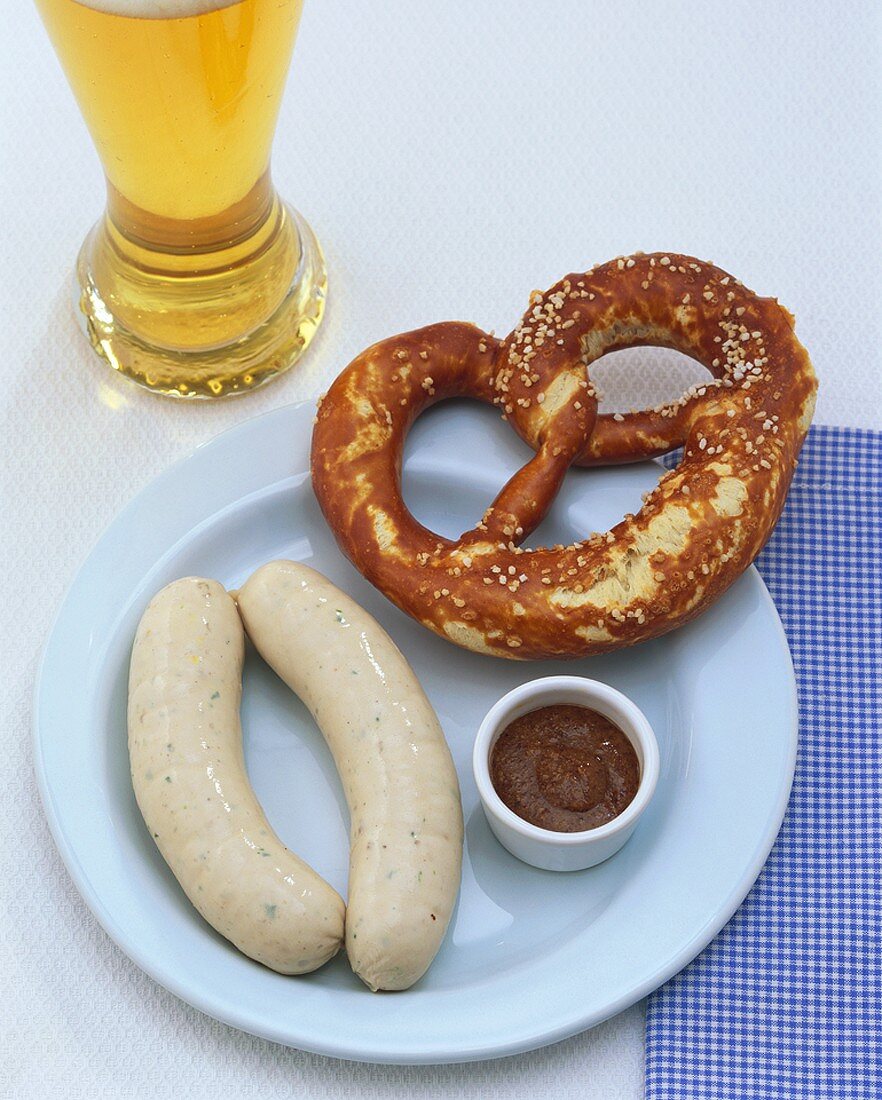 A pair of Weisswurst (white sausages), pretzel & mild mustard