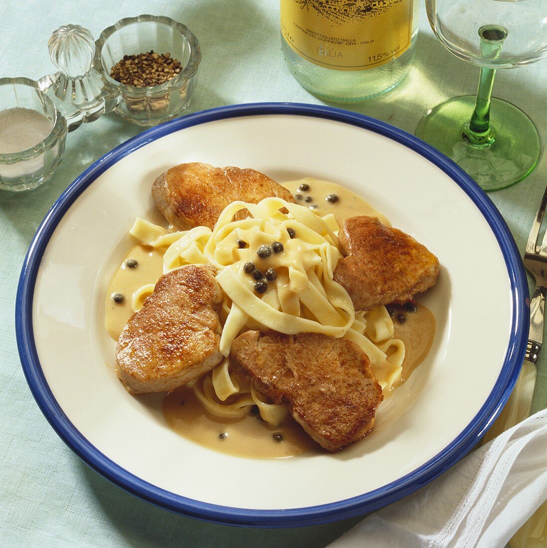 Pork fillet with pepper cream sauce on fettuccine