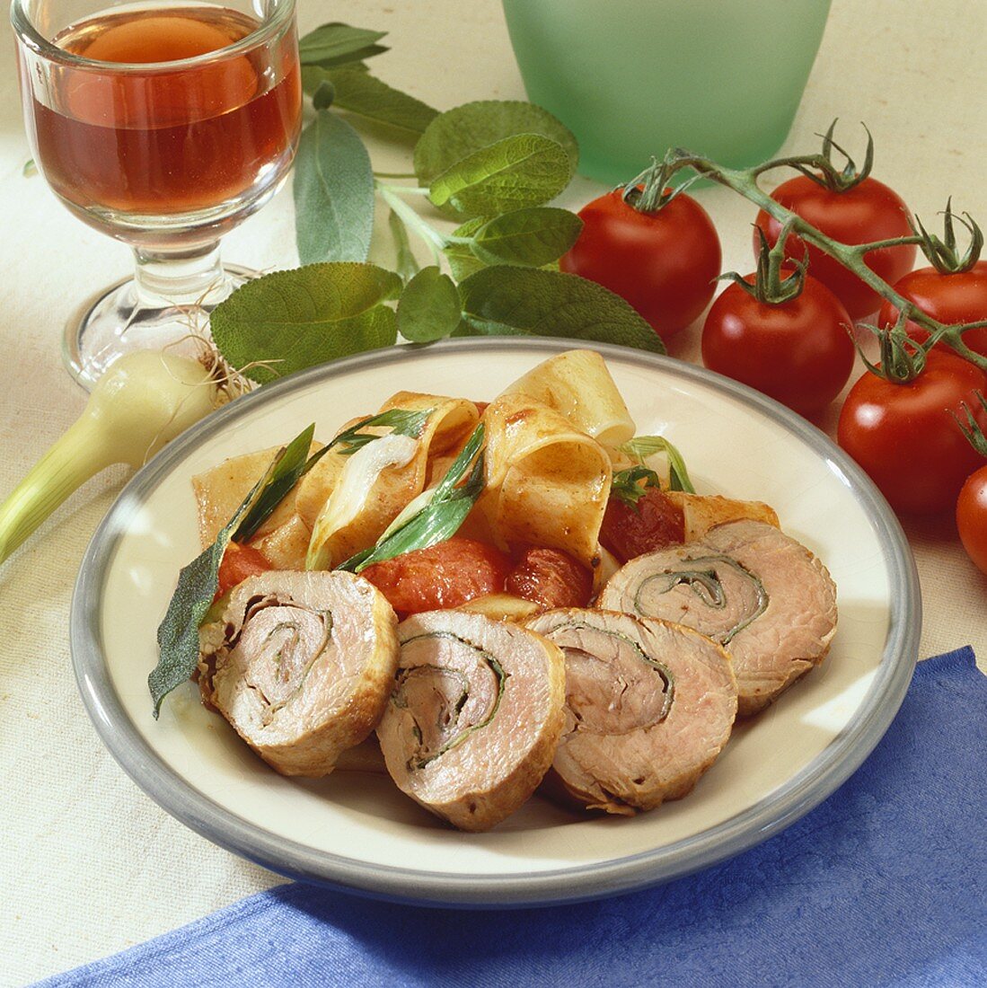 Stuffed pork roulades with tomatoes and broad ribbon pasta