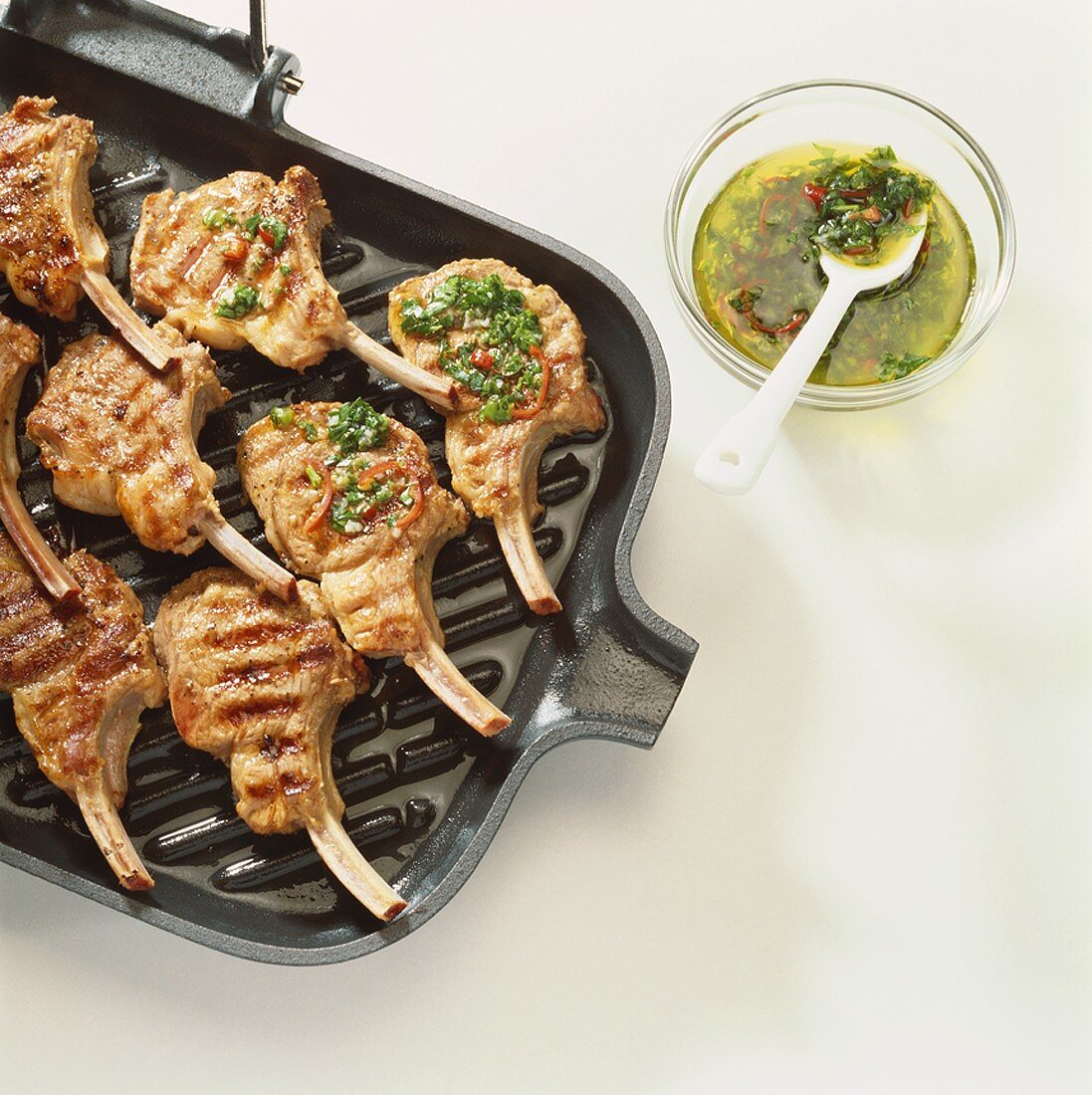 Lamb chops with herb oil on a grill pan