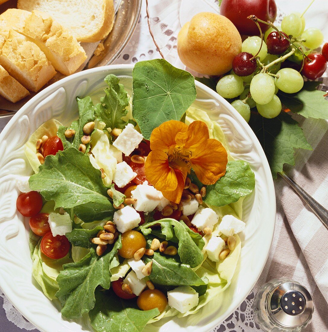 Mixed summer salad with sheep's cheese and pine nuts