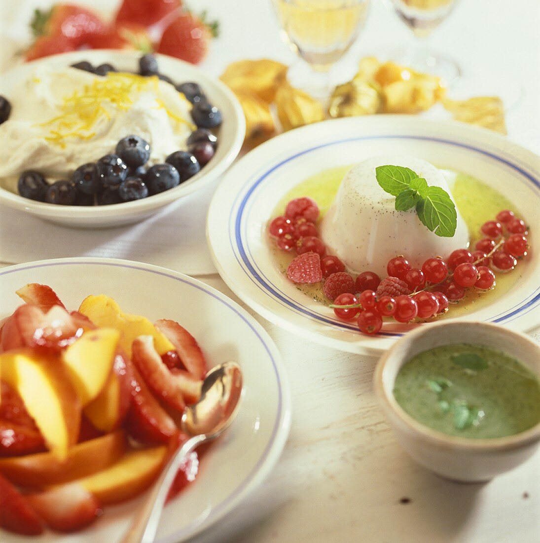 Fruit salad, panna cotta and blueberries with lemon cream