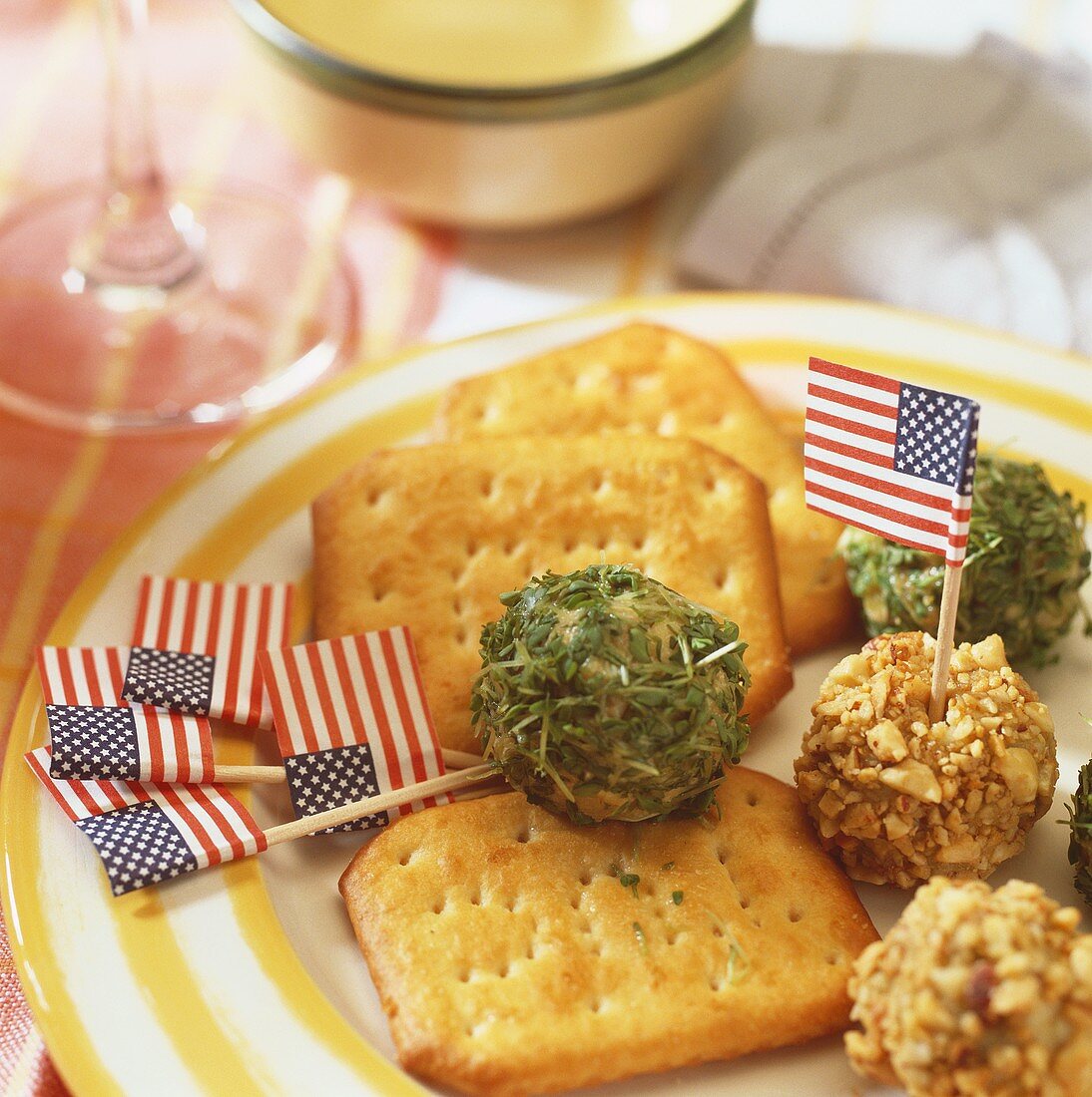 Crackers and cream cheese balls coated in nuts and herbs
