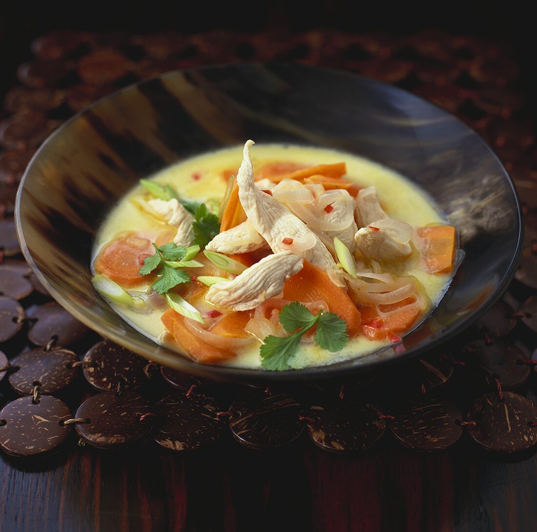 Coconut and chicken soup with vegetables