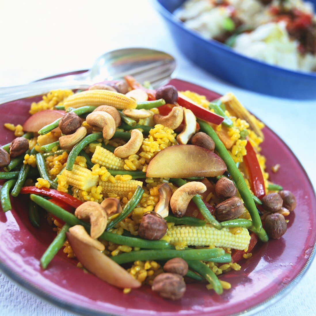 Biryani-style rice dish with vegetables, nectarine, nuts