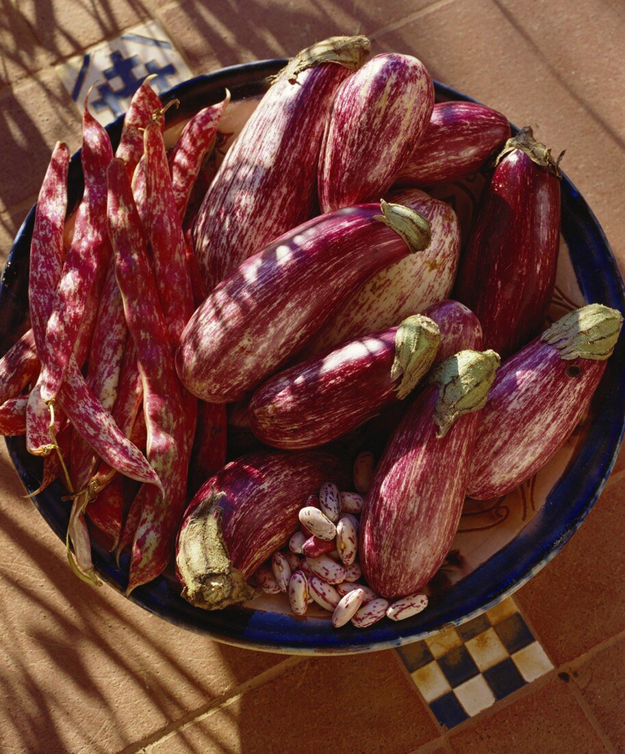 Striped aubergines and red and white speckled beans