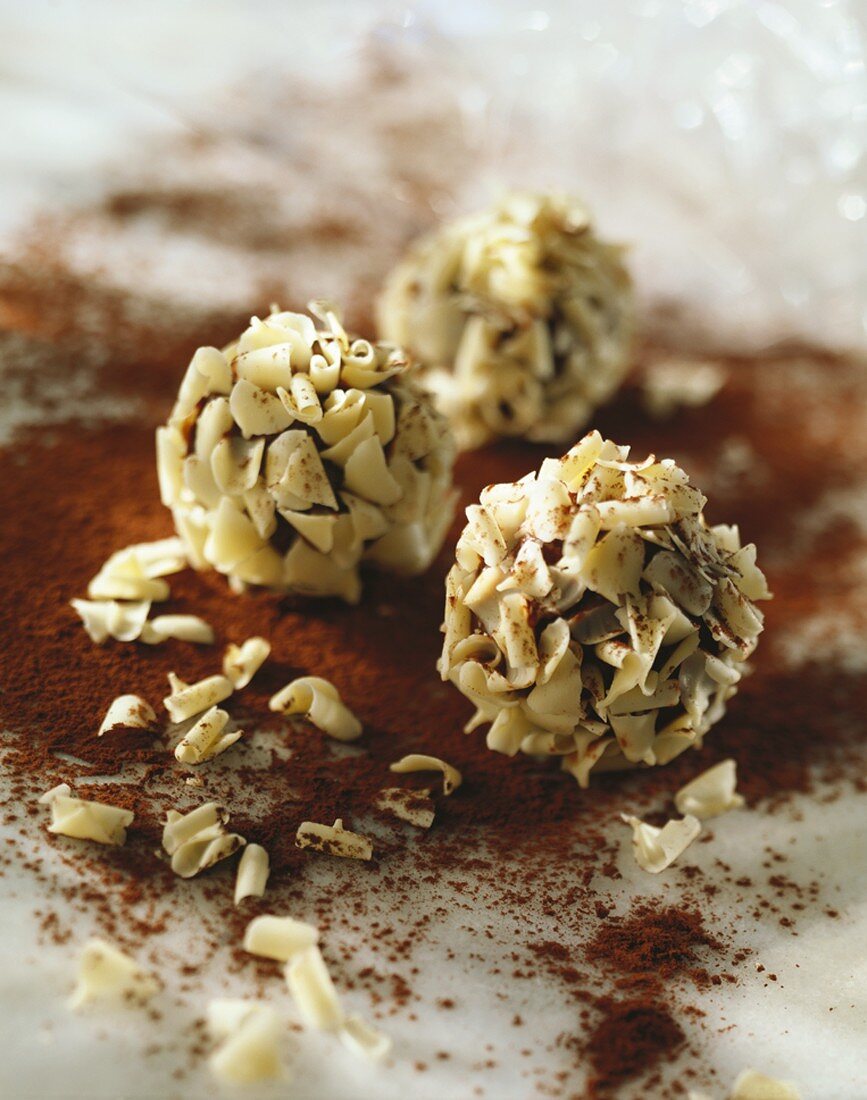 Chocolate truffles coated in white chocolate flakes