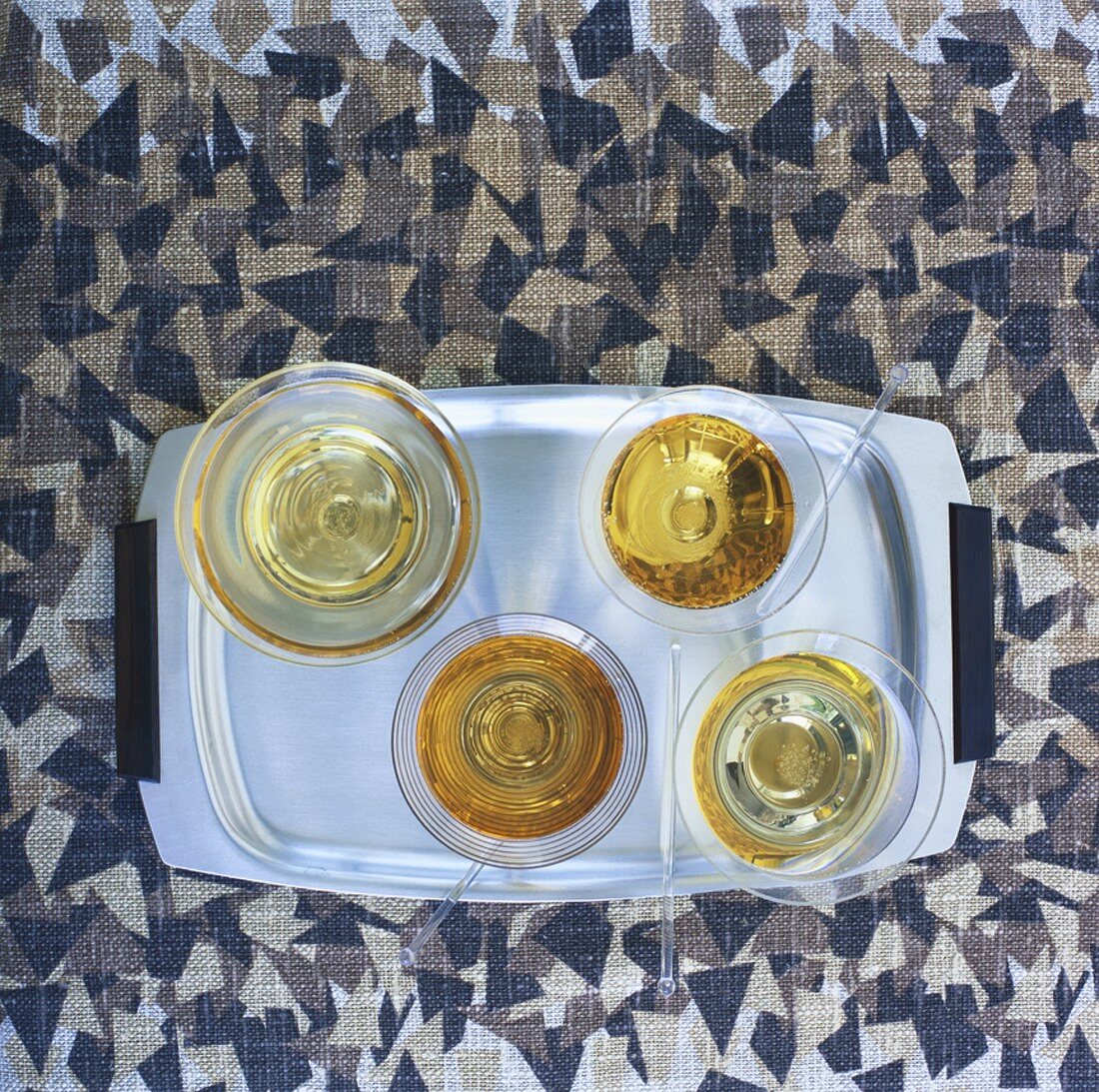 Four glasses of sparkling wine on a tray