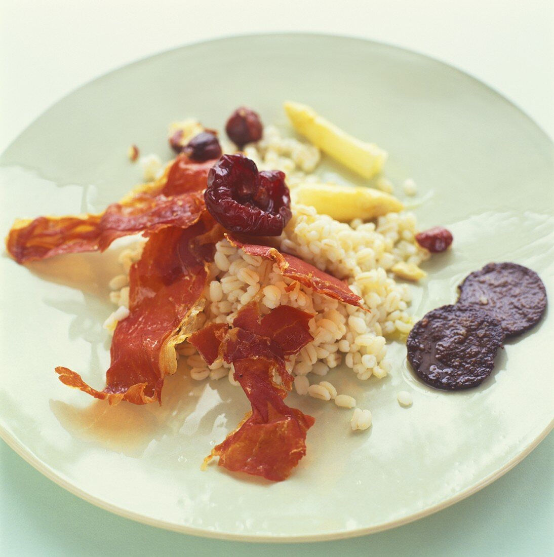 Pearl barley with dried plums and Parma ham