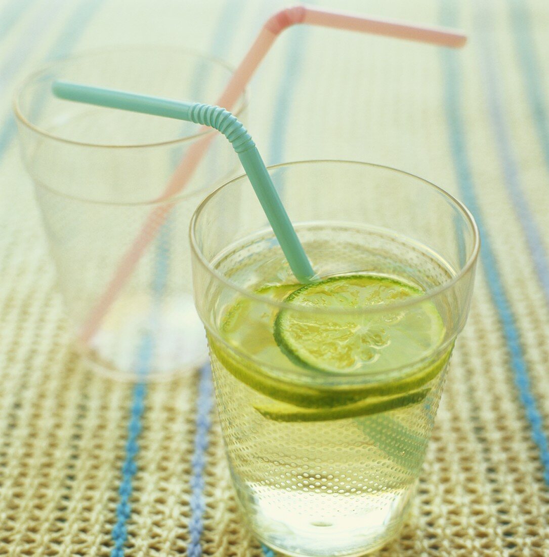 Limeade in a glass with a straw