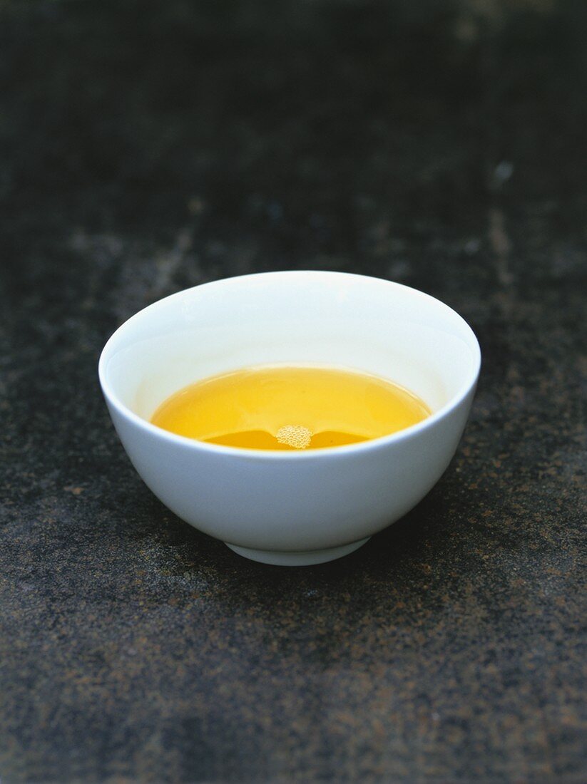 Walnut oil in a small white porcelain bowl