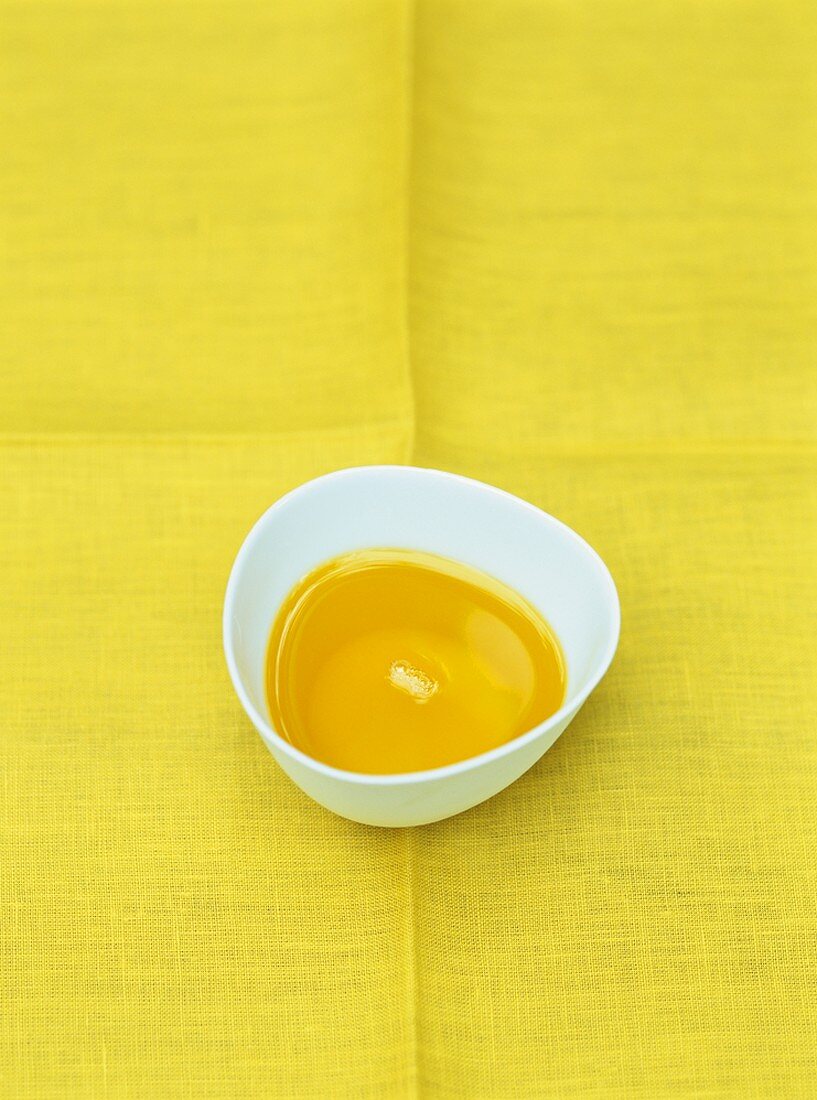 Rapeseed oil in a small white porcelain bowl