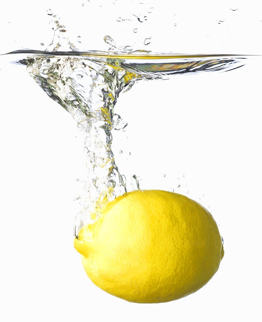 A lemon falling into water