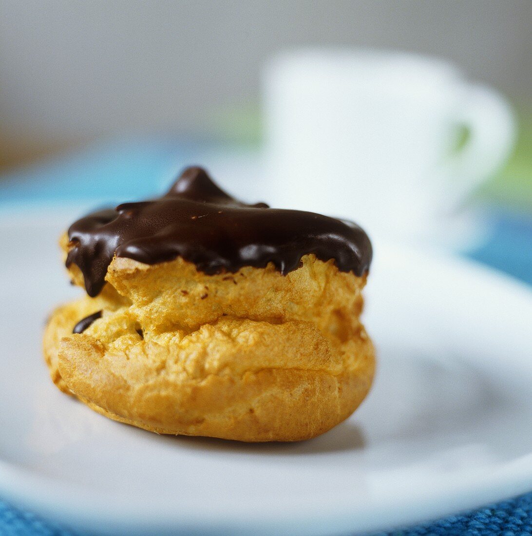 A profiterole with chocolate icing