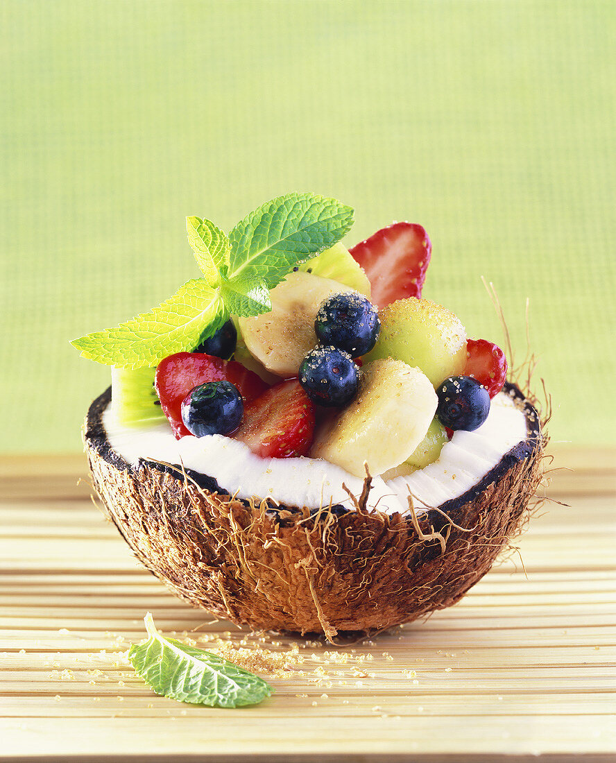 Fruit salad served in a fresh coconut half