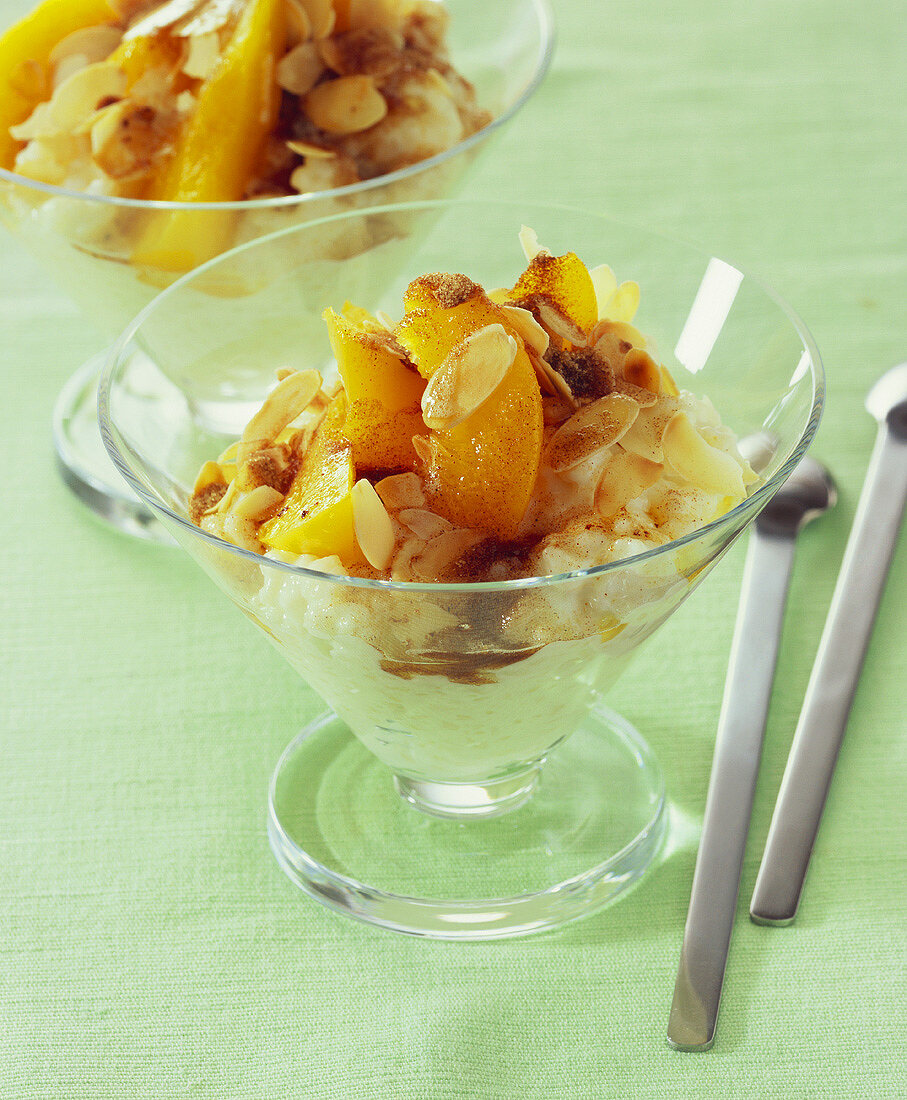 Rice pudding with peach slices and flaked almonds