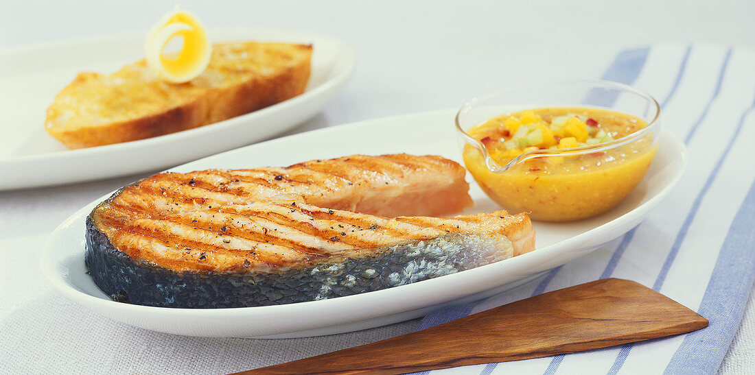 Grilled salmon steak with mango and cucumber salsa