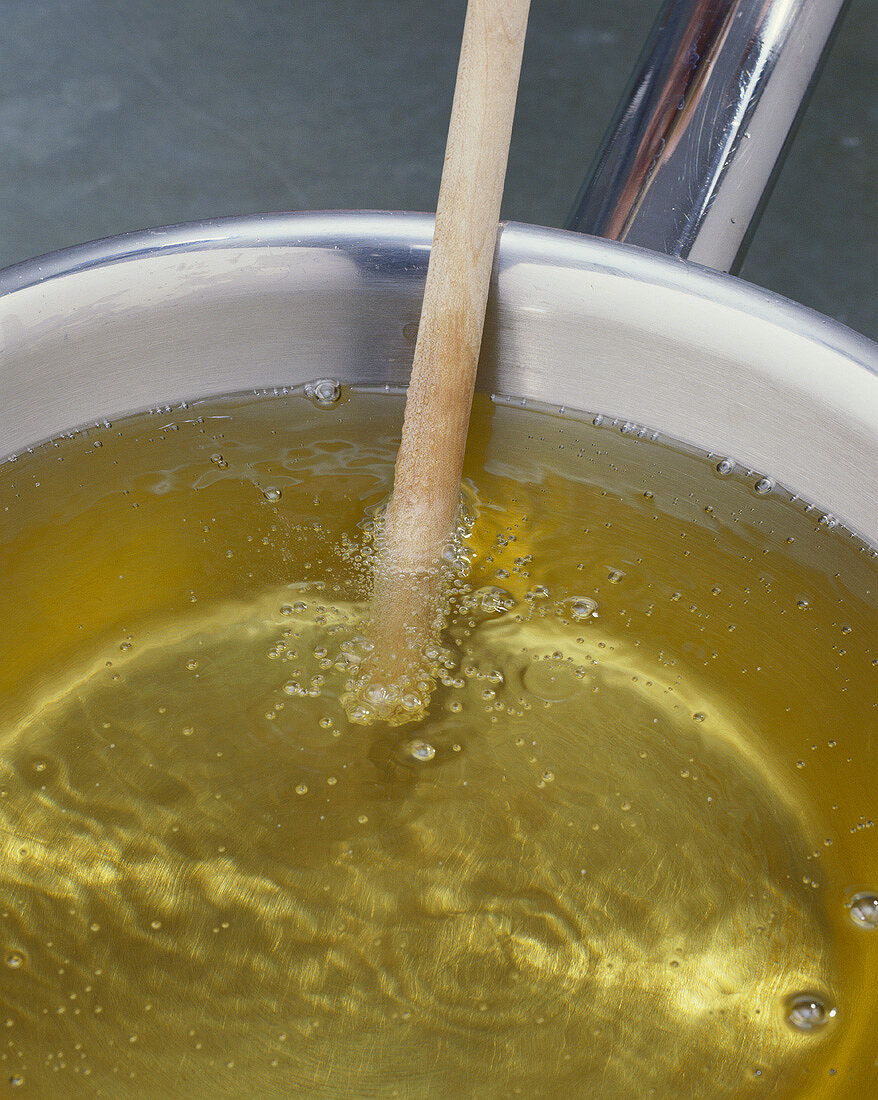Testing oil temperature with a wooden stick