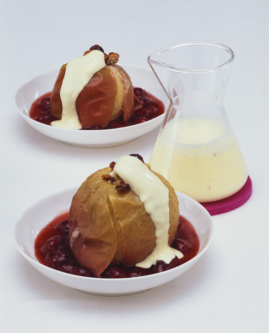 Baked apples on cranberry puree with custard