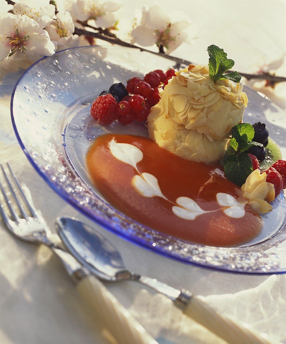 Almond balls on strawberry sauce with fresh berries