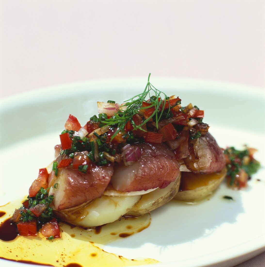 Matjes herrings with tomato salad on potato slices