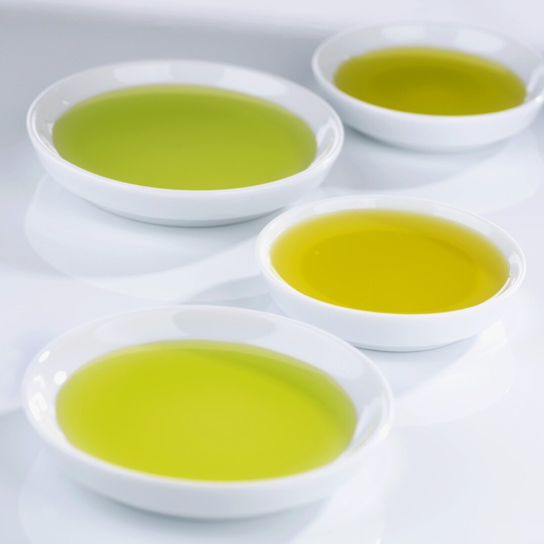 Small bowls of different kinds of olive oil