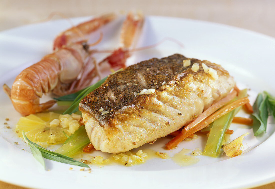 Catfish and Norway lobster with vegetables and lemon sauce