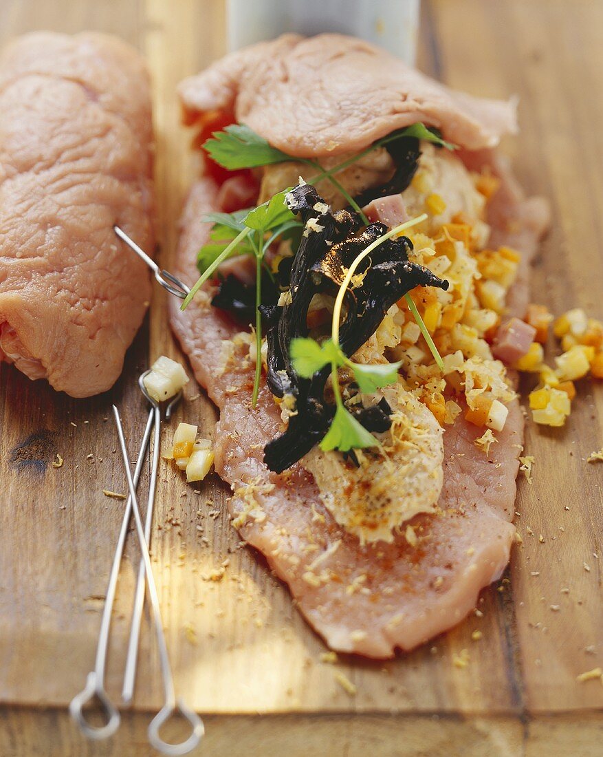 Making veal roulades with ham and vegetable stuffing