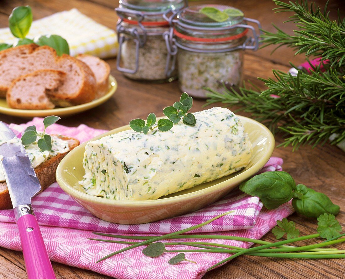 Home-made herb butter in small dish on table