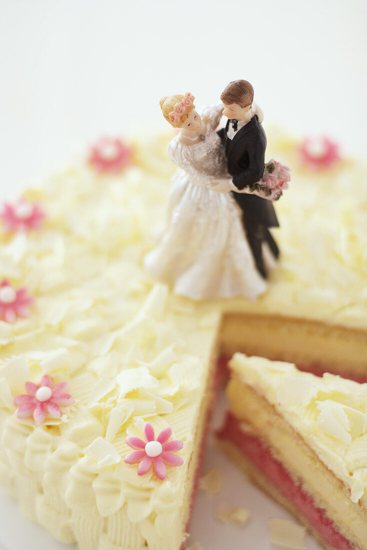 A wedding cake with a piece cut