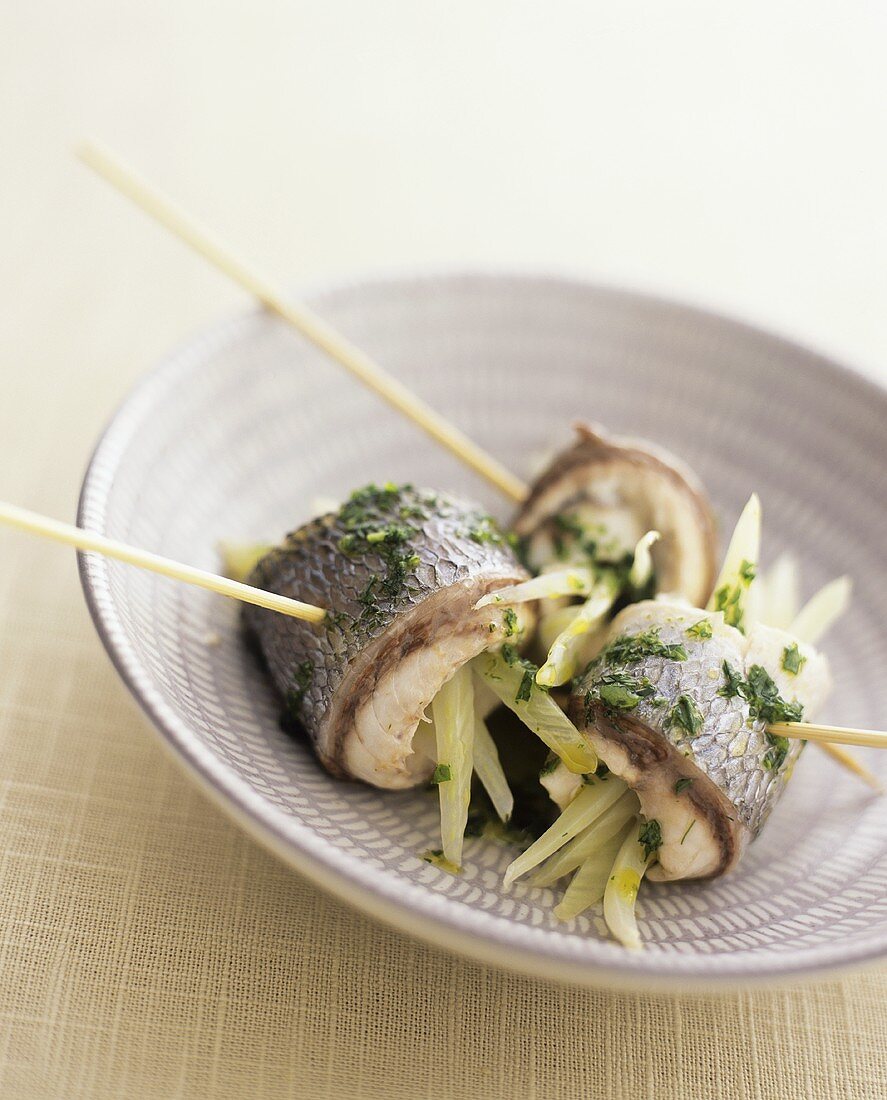 Seabream rolls filled with fennel, with rocket sauce