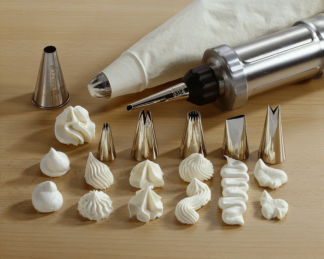 Piping bag with nozzles and piped meringue decorations