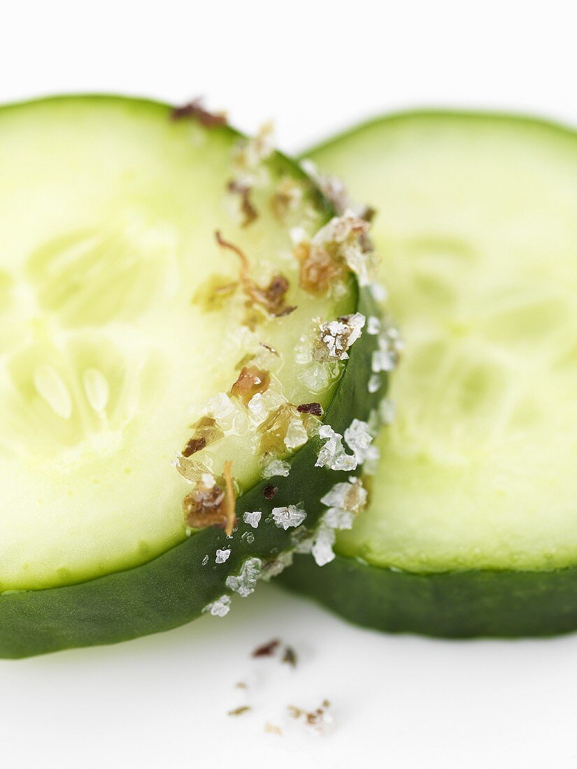Sea salt with seaweed on two slices of cucumber