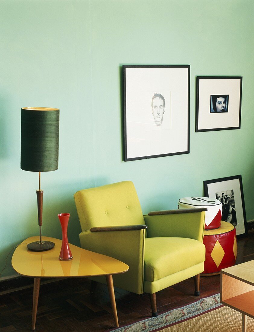 Green chair with side table and table lamp in retro style
