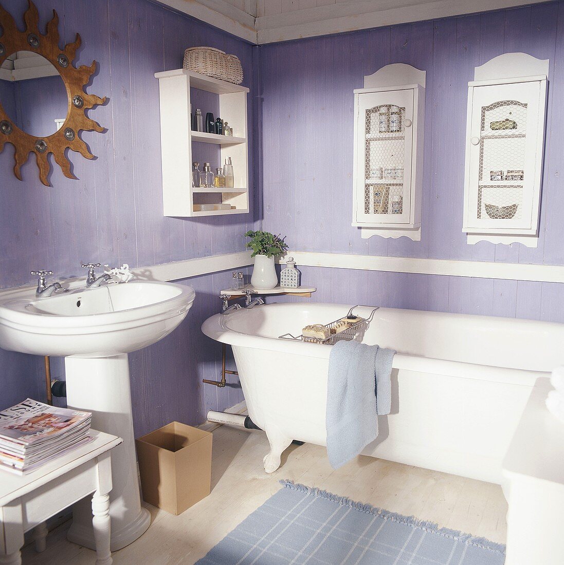 Nostalgic bathroom in pastel lilac with pedestal sink and antique bathtub