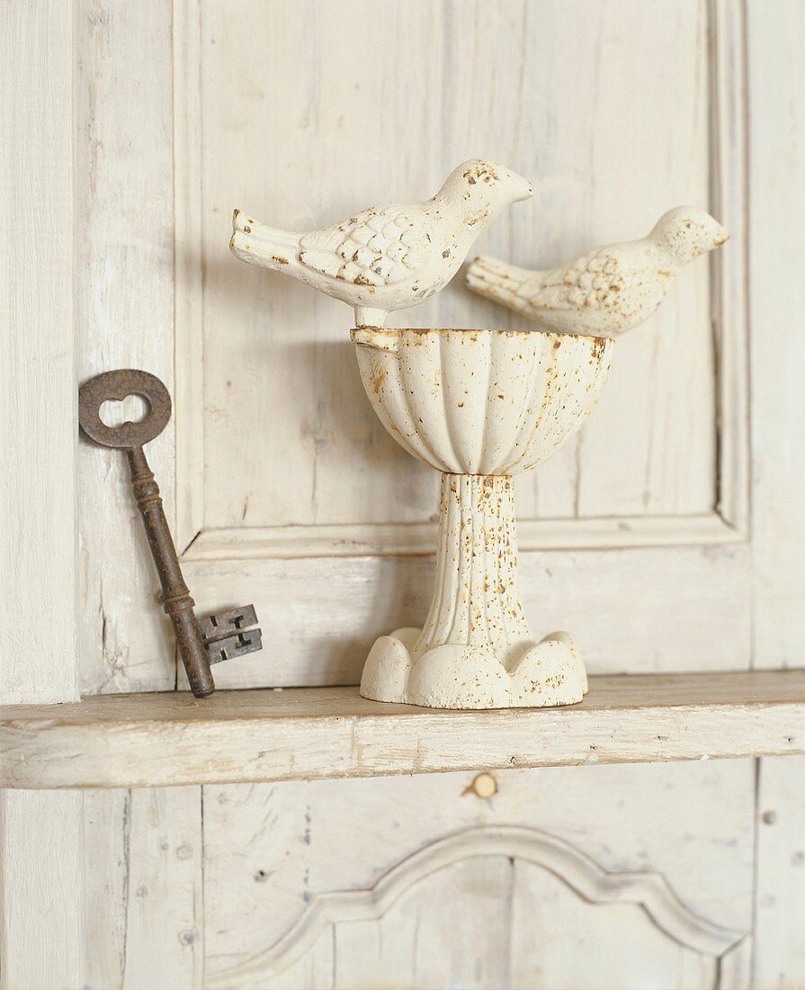 Rustic key and birdbath on cabinet