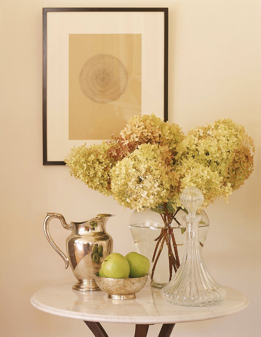 Flowers and apples on small table