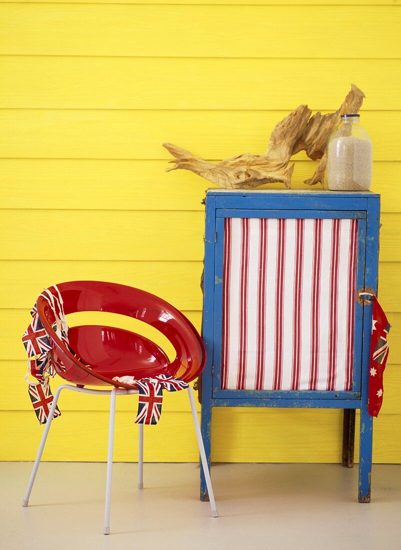 Chair and cabinet against yellow wall