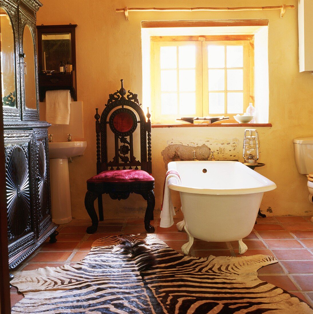 Zebra-skin rug in front of free-standing bathtub