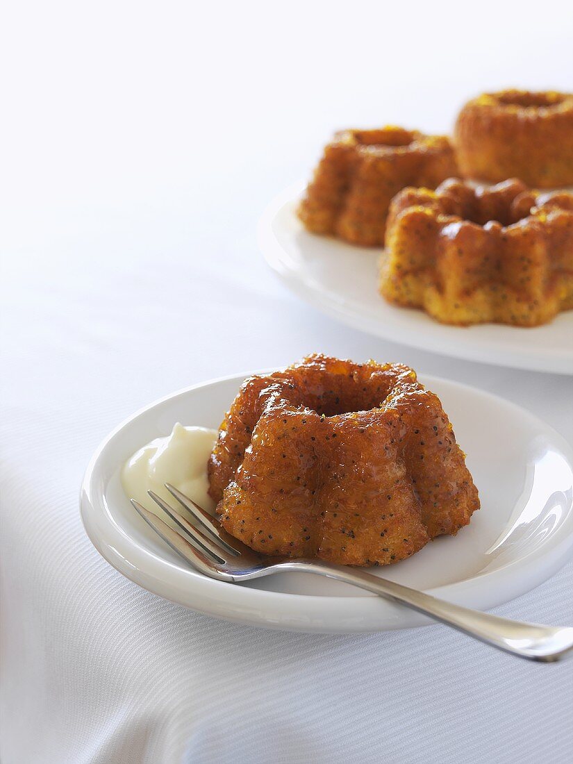 Several small orange cakes with cream