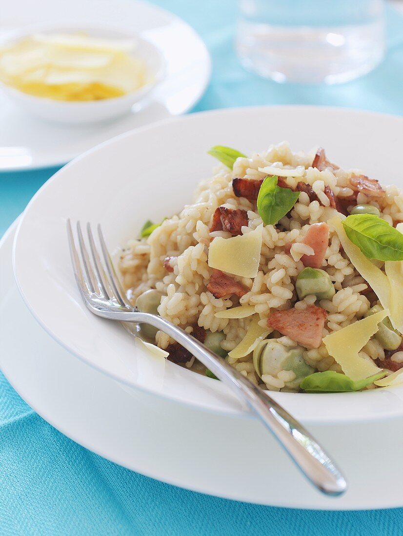 A plate of risotto with beans, ham and Parmesan