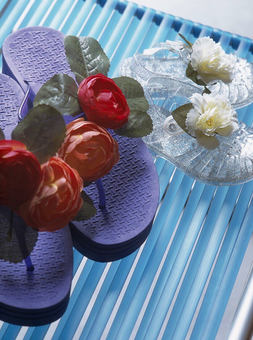 Flip-flops and jelly sandals decorated with flowers