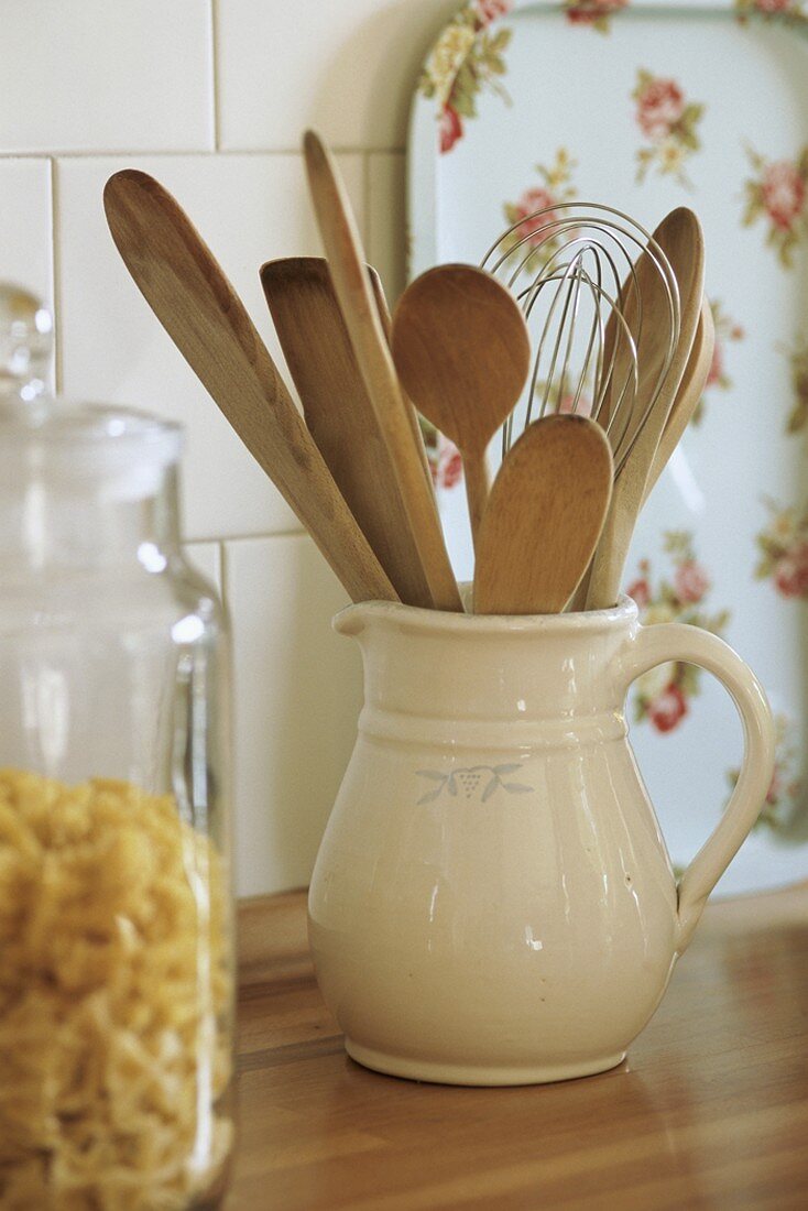 A jug of wooden utensils