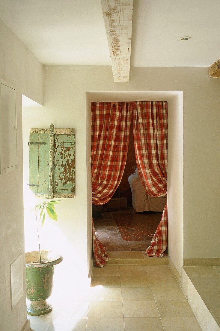 A hallway with a view into a living room