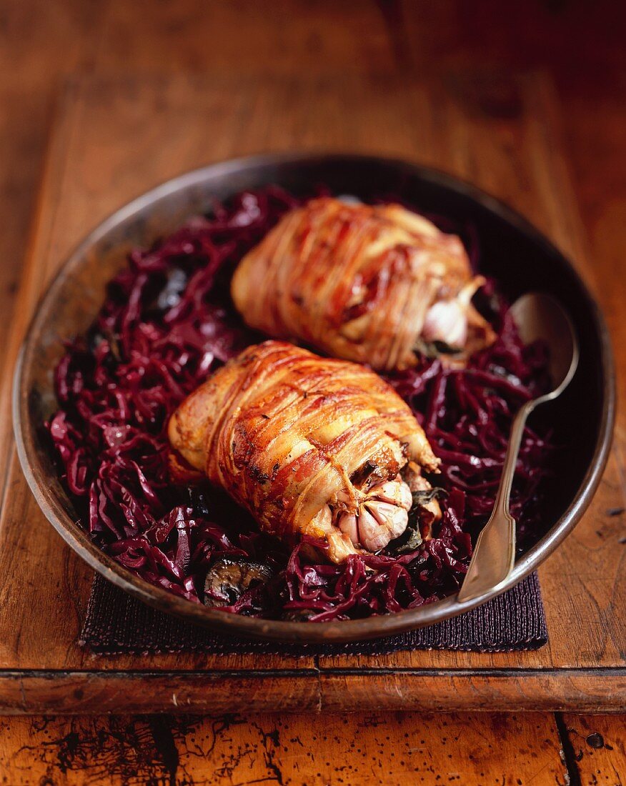 Bacon-wrapped quails on red cabbage
