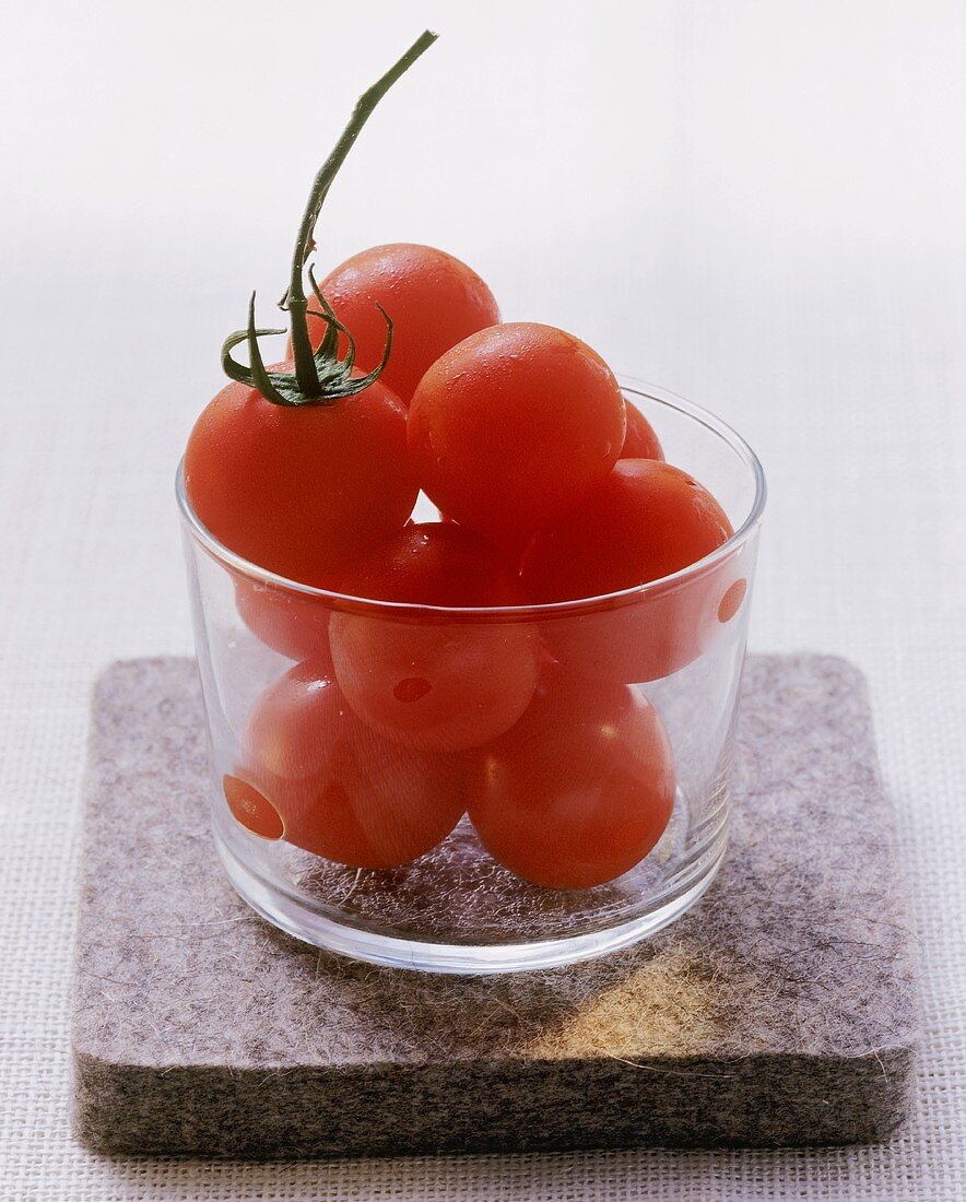 Several tomatoes in a glass