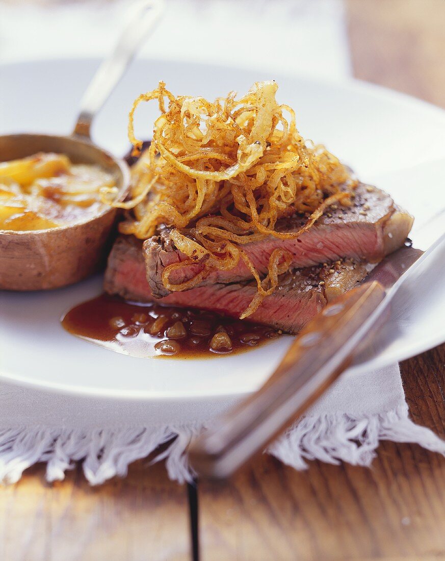 Steak and onions with potato gratin