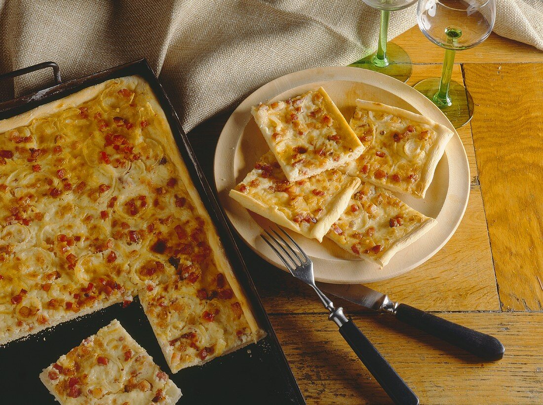 Tarte flambée on baking tray and plate