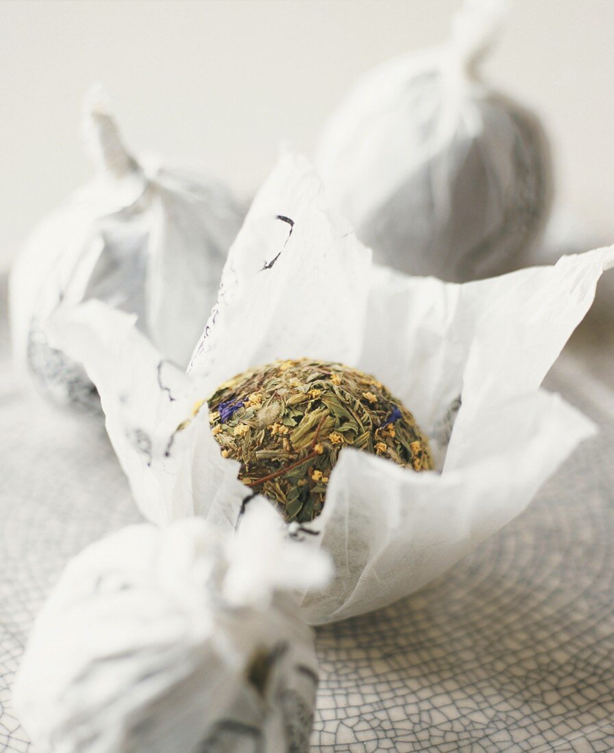 Balls of dried tea leaves in paper