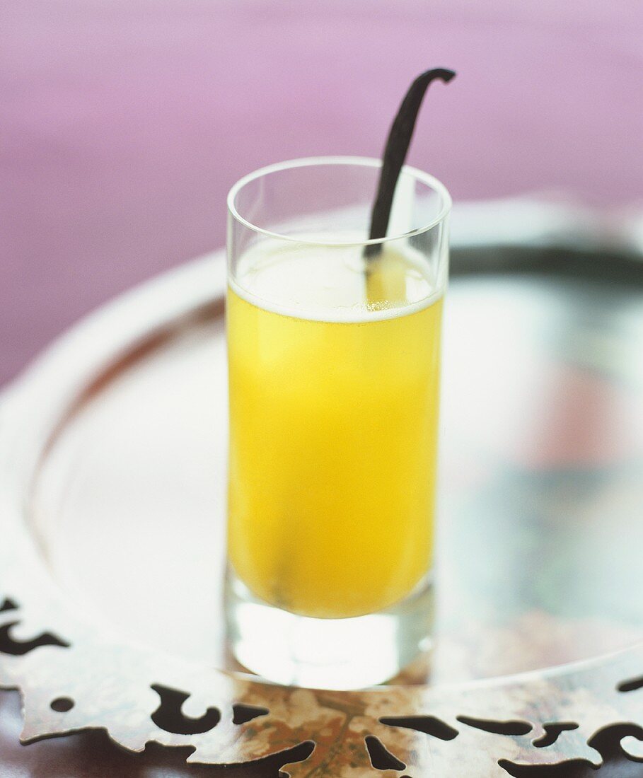 An apricot champagne cocktail with a vanilla pod